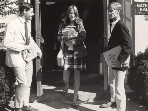 Female Trinity College student with books leaving Mather Hall at registration time, 1969.