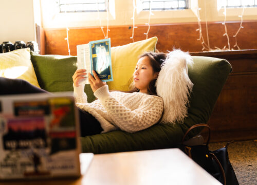 A trinity college student reading in their residence hall