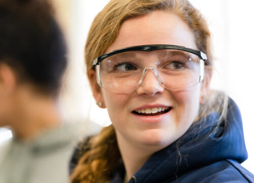 An inspired Trinity college student wearing safety goggles