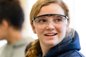 An inspired Trinity college student wearing safety goggles