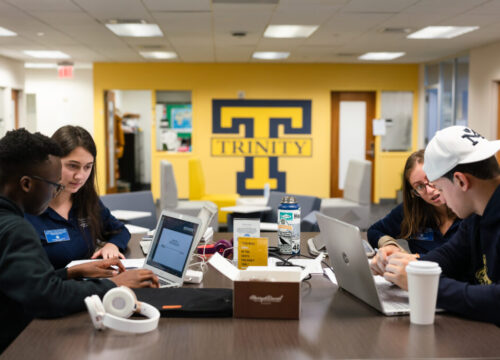 Trinity College students working together at a table