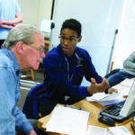 A Trinity College student assisting the community with accounting skills