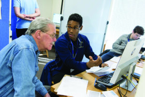 A Trinity College student assisting the community with accounting skills