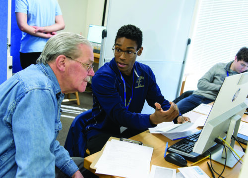 A Trinity College student assisting the community with accounting skills