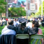 A 2021 Trinity College Graduate sitting with family