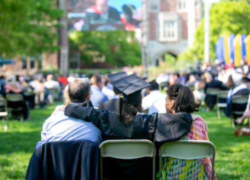 A 2021 Trinity College Graduate sitting with family