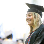 A smiling Trinity College graduate