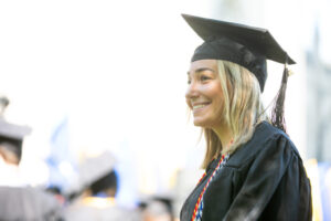 A smiling Trinity College graduate