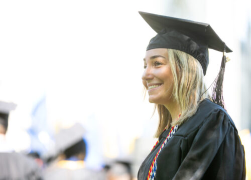 A smiling Trinity College graduate
