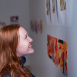 Trinity college student admiring artwork on campus