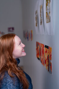 Trinity college student admiring artwork on campus