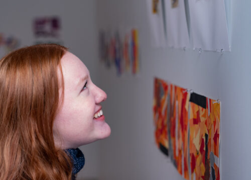 Trinity college student admiring artwork on campus