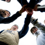 The Trinity College Women's Lacrosse Team in a huddle