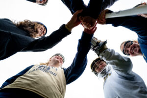 The Trinity College Women's Lacrosse Team in a huddle