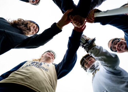 The Trinity College Women's Lacrosse Team in a huddle