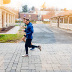 Trinity college student athletes running through campus