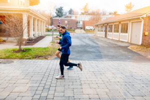 Trinity college student athletes running through campus