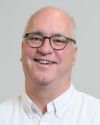 Photo of Kent Dunlap smiling with dark rimmed glasses