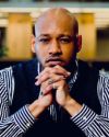 David Sterling Brown with his hands clasped in front of his chin