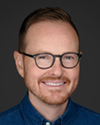 Photo of Prof Grubb with dark rimmed glasses and reddish beard