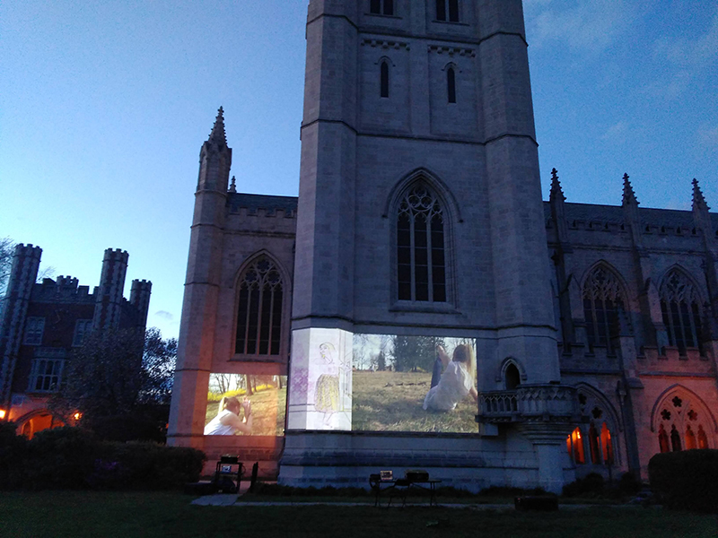 a film projected onto the side of the Trinity College chapel