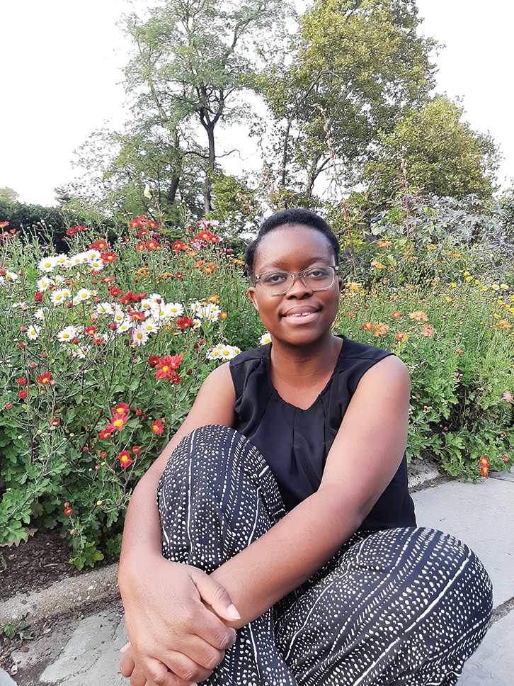 Salima Etoka sitting by a garden