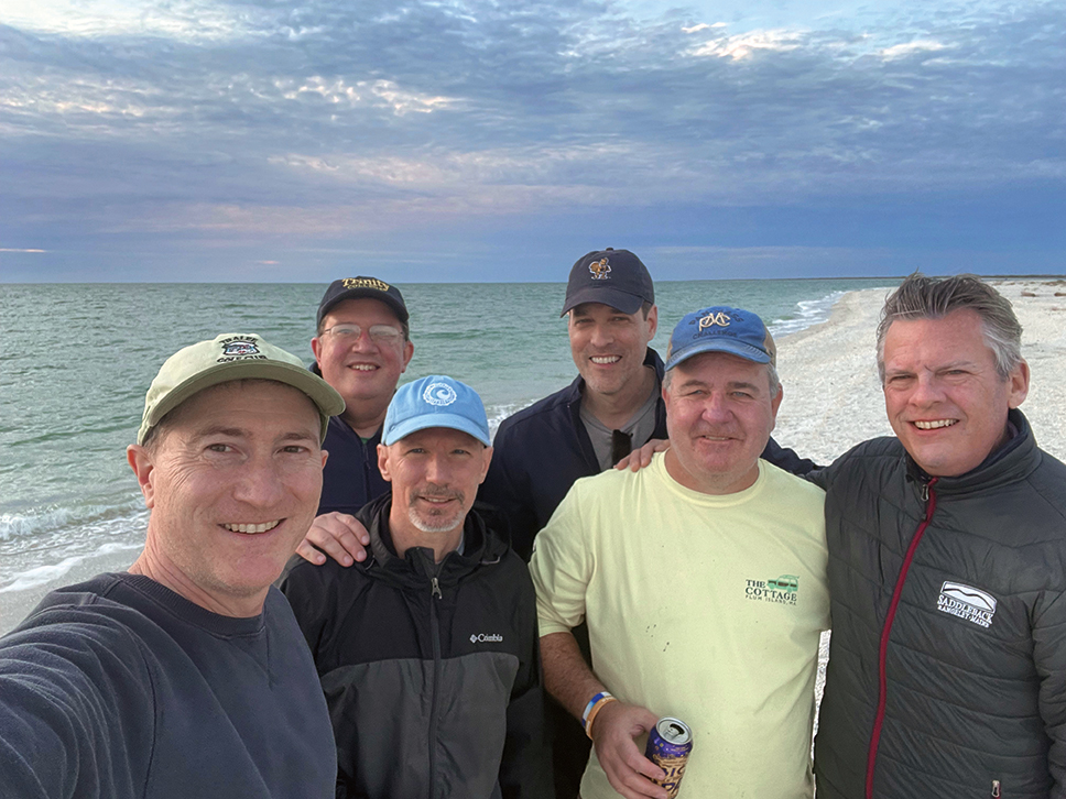 Jeff Proulx, Ray Hannan, Ed Troiano, Paul Diaz, Neil Walsh, and Jamie Murphy on a beach