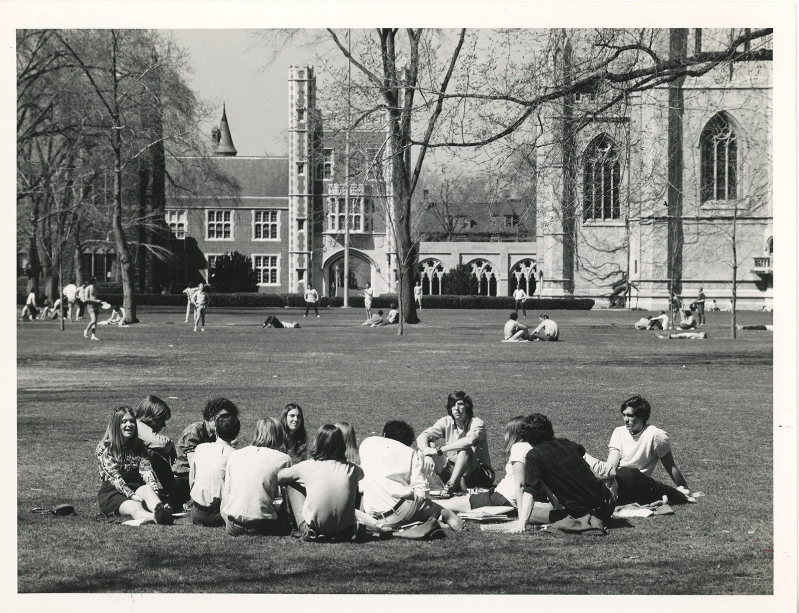students sitting on the grass on the main quad in a black and white photo from 1972