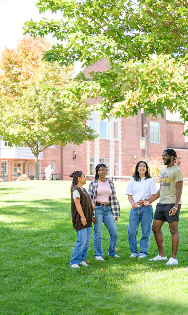 P.R.I.D.E. leaders Jessica Cruz ’26, Ashley Nelson ’26, Lilly Supples ’26, and Aleem Ogunsanya ’26 gather in front of Mather Hall.