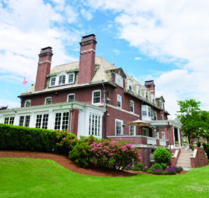 Large brick building with a beautifully manicured lawn