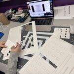 Student assembling laser cut pieces