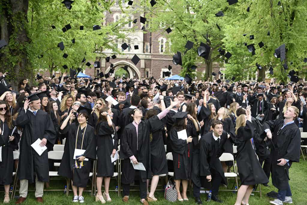 grads throwing caps in air