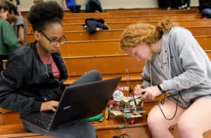 Trinity students make last-minute adjustments to their robot.