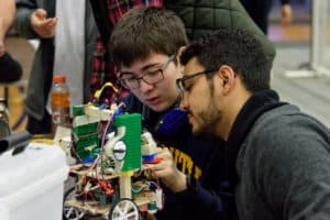 Trinity students with a robot at the annual robot contest