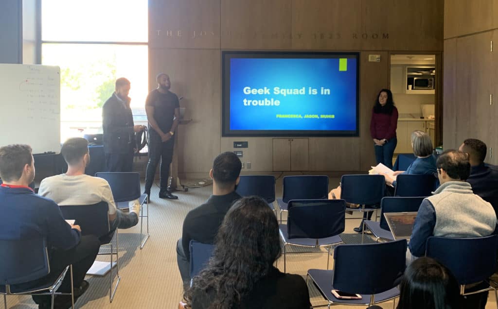 A group of new Infosys employees—including Trinity alumna Francesca L. Velarde ’19 (right)—present to the group during a training module held in Trinity’s Raether Library and Information Technology Center.