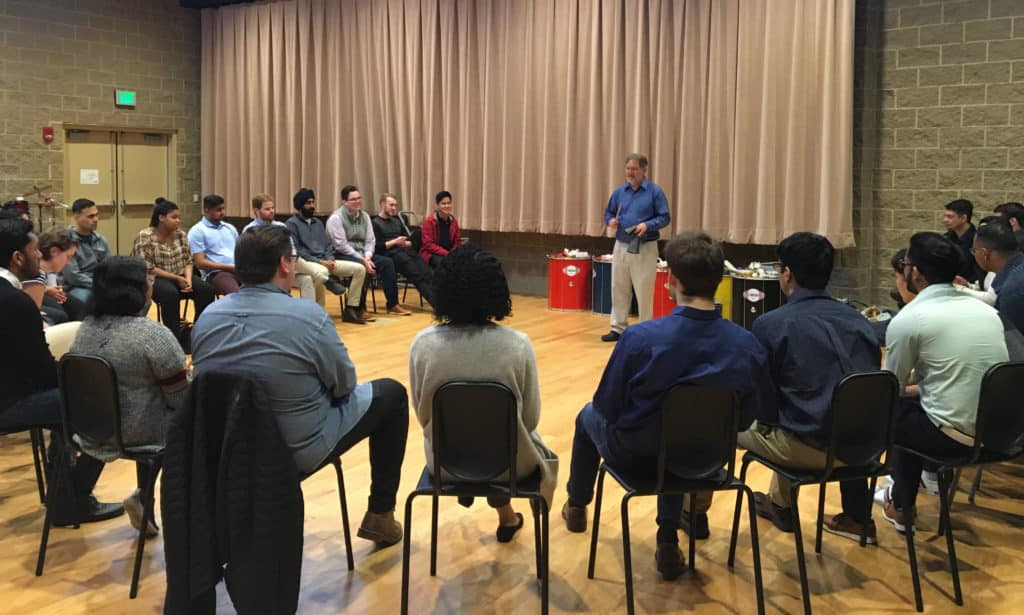 Trinity Associate Professor of Music Eric Galm instructs an Infosys training group on active listening in Trinity’s Gruss Music Center.