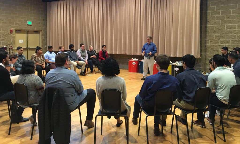 Trinity Associate Professor of Music Eric Galm instructs an Infosys training group on active listening in Trinity’s Gruss Music Center. 