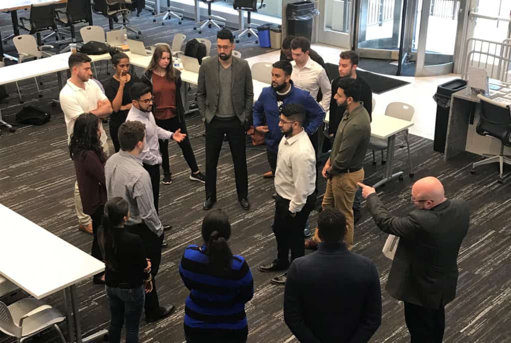 Joe Catrino (bottom right), Trinity’s director of career development and special assistant to the vice president for innovation, leads an Infosys training session at Trinity’s Liberal Arts Action Lab on Constitution Plaza.