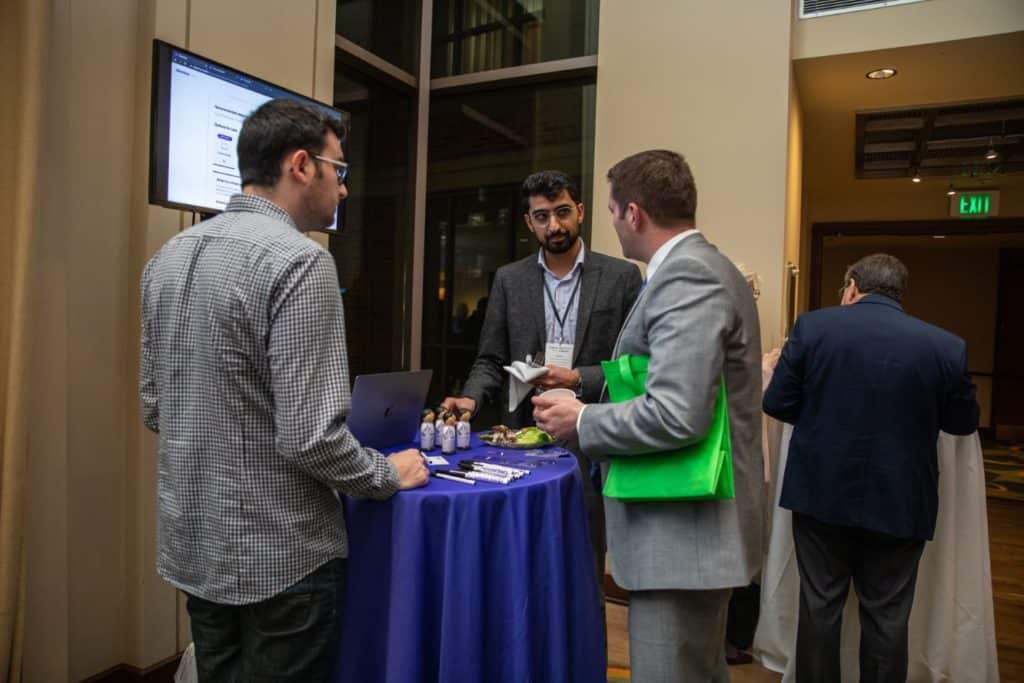 Clearstep CEO Adeel Malike (center) and CMO/Chief of Design Peter Garber (left), both co-founders, networking with a Demo Day attendee after pitches.