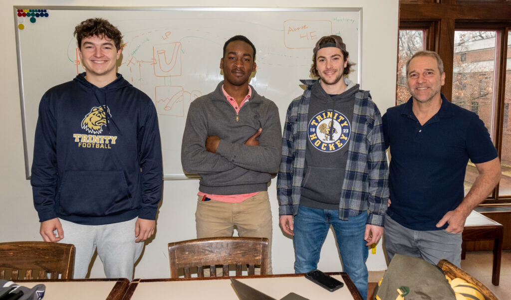 Kevin Clark ’23 (left) with Maalik McPherson ’23, Eric Sinson ’23, and Professor of Engineering John Mertens.