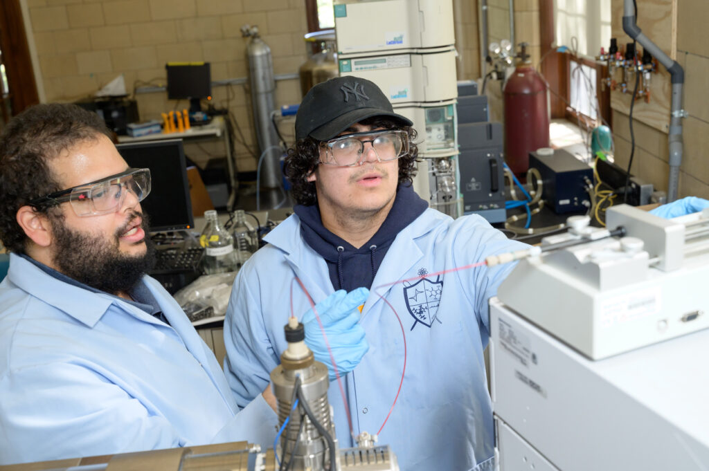 Jonathan T. Ashby ’09, assistant professor of chemistry, works in the lab with Ethan Andujar ’27. Photos by Nick Caito.