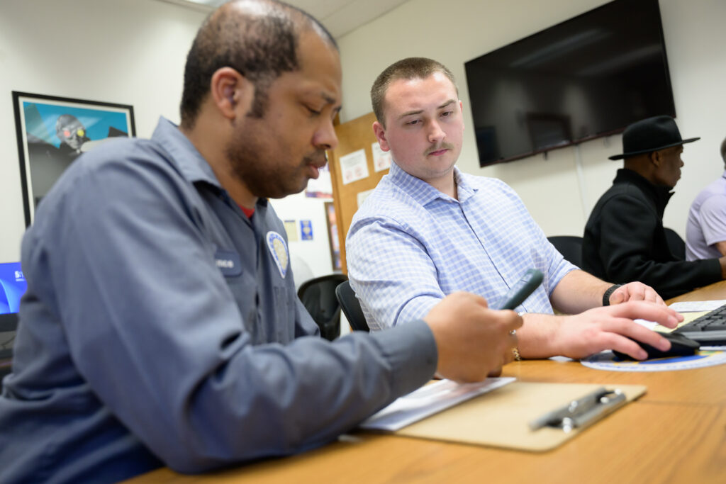 Trinity students help to prepare free tax returns for Hartford residents at the Volunteer Income Tax Assistance (VITA) clinic located at Trinfo.