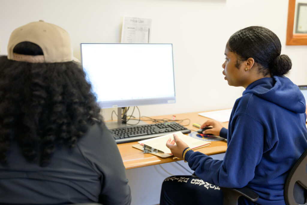 Trinity students help to prepare free tax returns for Hartford residents at the Volunteer Income Tax Assistance (VITA) clinic located at Trinfo.