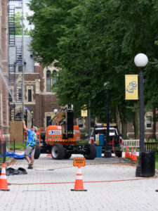 Heavy machinery digging a big hole in order for a pipe to be repaired.